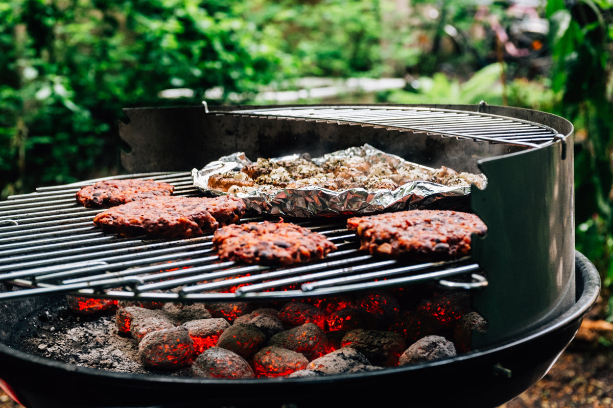 Food cooking on a charcoal barbecue
