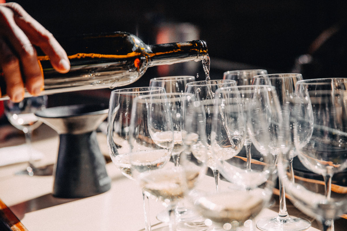 Wine being poured into tasting glasses