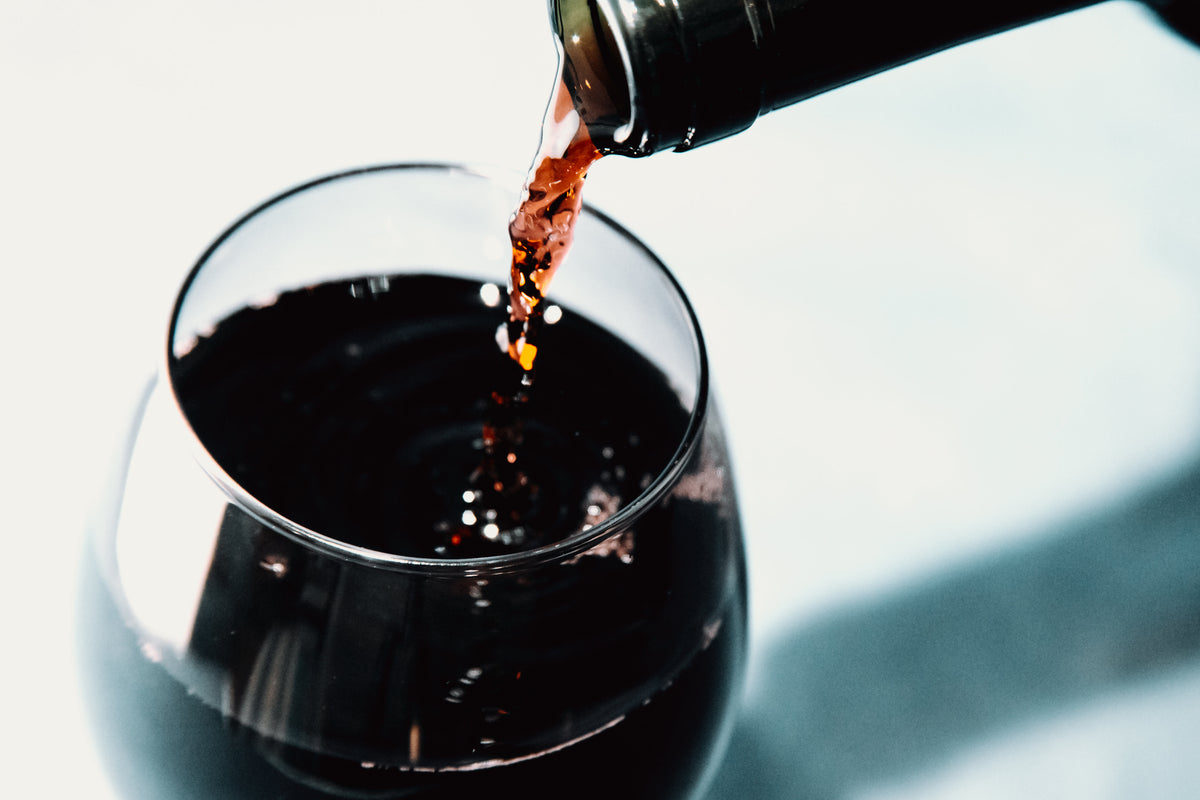 Red wine pouring into a glass